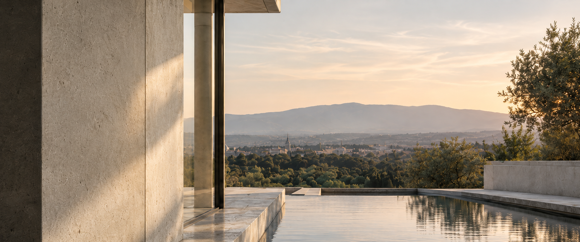 A limestone terrace and reflecting pool overlooking a tree-lined valley.